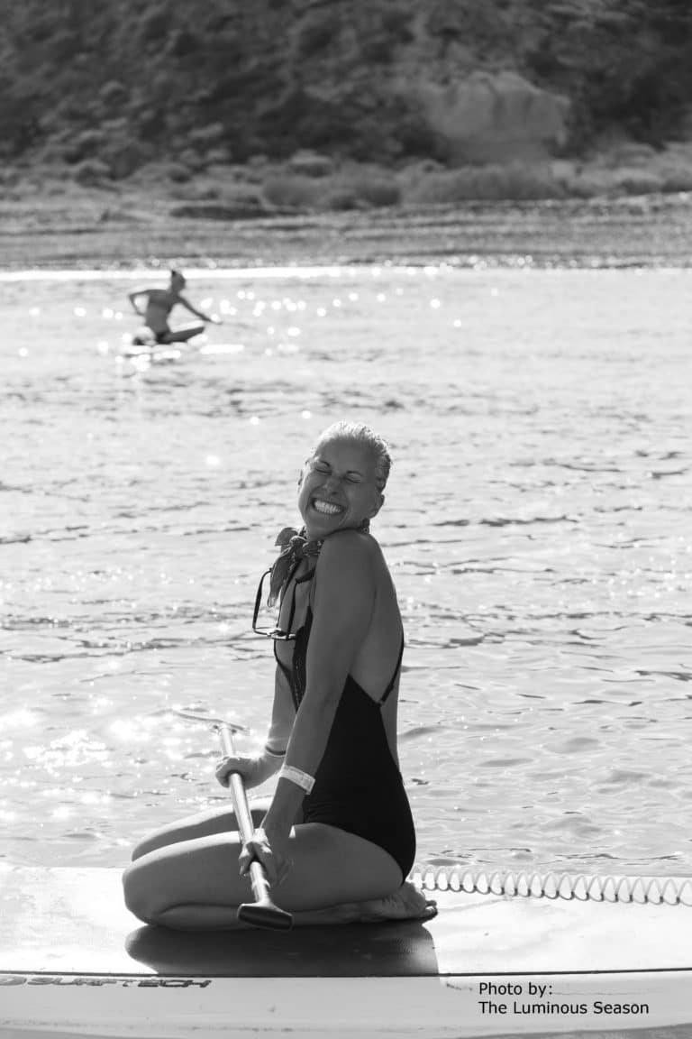 happy smiling lady on paddle board rental