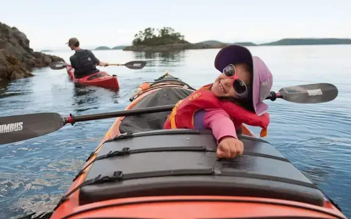 A happy child exploring the San Juan Islands in a rental sea kayak