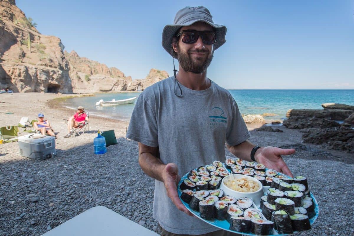 smiling guide with fresh sea food on a sea adventure la paz